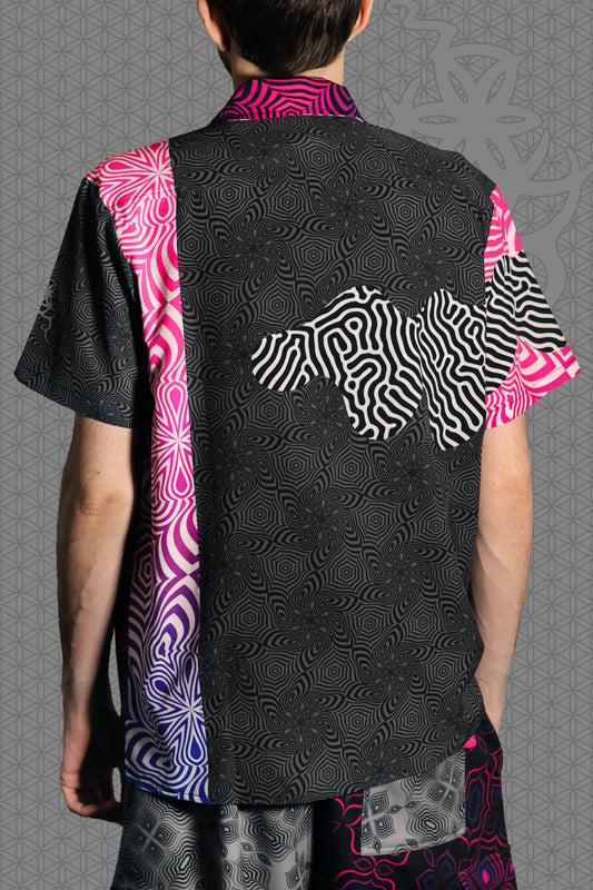 back view psychedelic rave camp shirt with neon pink, purple, and blue geometric optical patterns and gradient panels