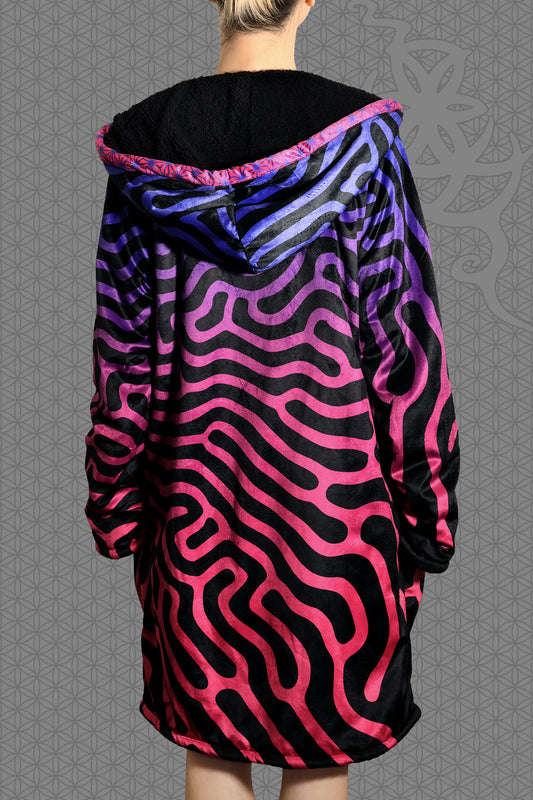back view psychedelic hooded zip jacket with magenta-to-purple Turing pattern and reaction diffusion on black, contrasting rainbow geometric trim along the zipper and hood, and soft black fleece lining