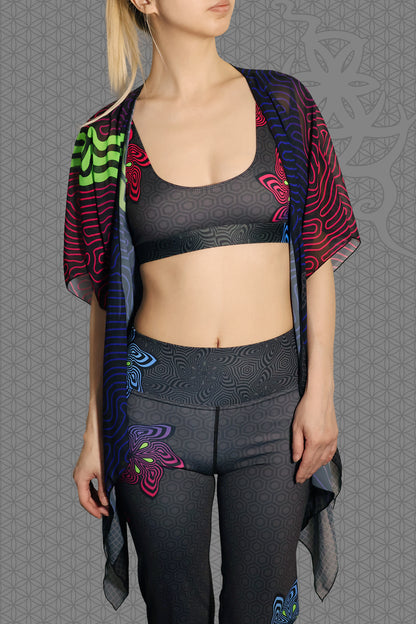 front view sheer chiffon psychedelic rave kimono with neon green, blue, and pink contour patterns on black worn over festival outfit