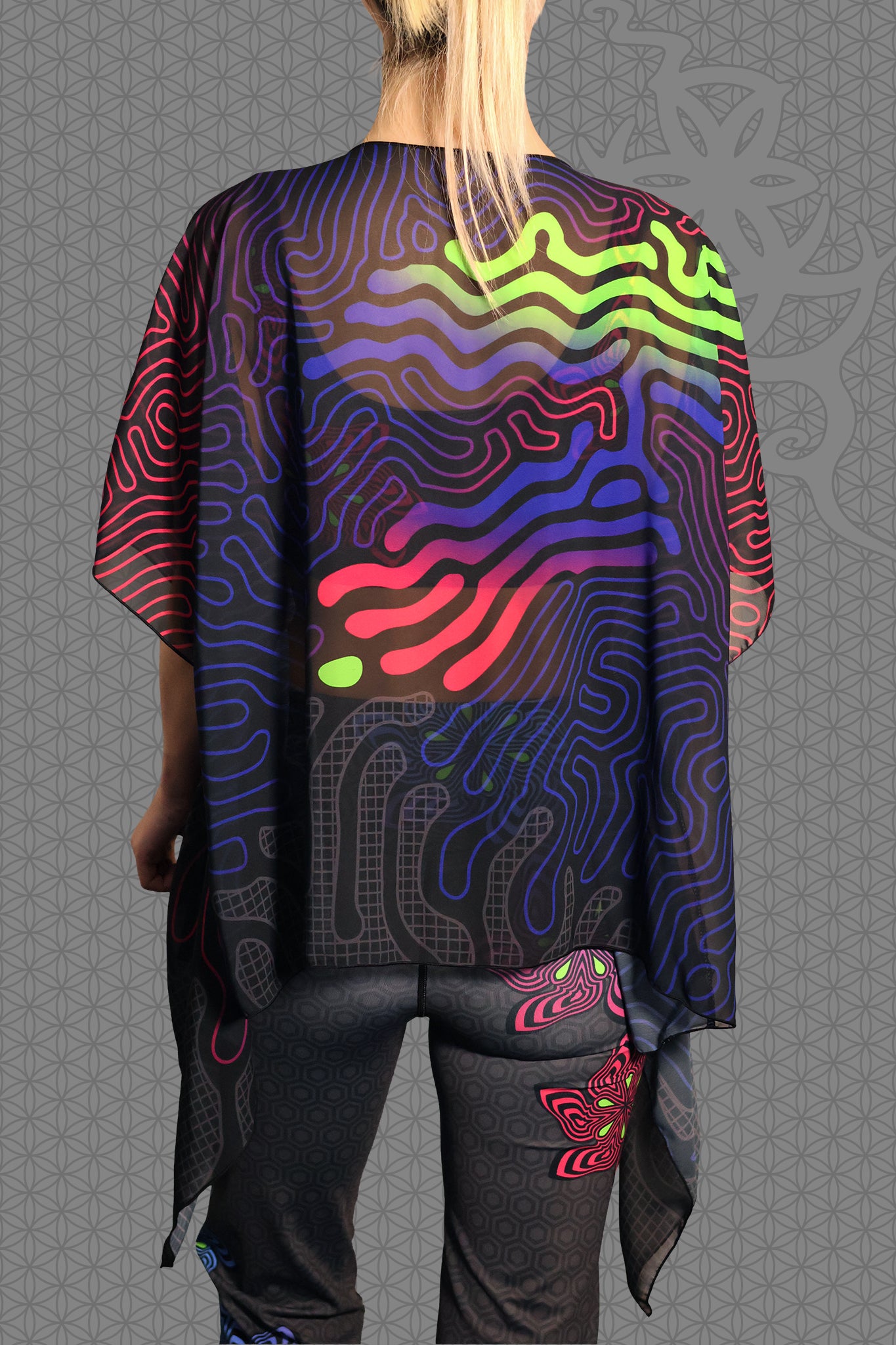 back view sheer chiffon psychedelic rave kimono with neon green, blue, and pink contour patterns on black worn over festival outfit