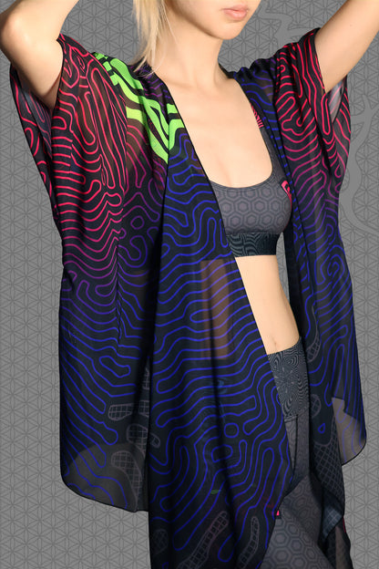 detail view sheer chiffon psychedelic rave kimono with neon green, blue, and pink contour patterns on black worn over festival outfit