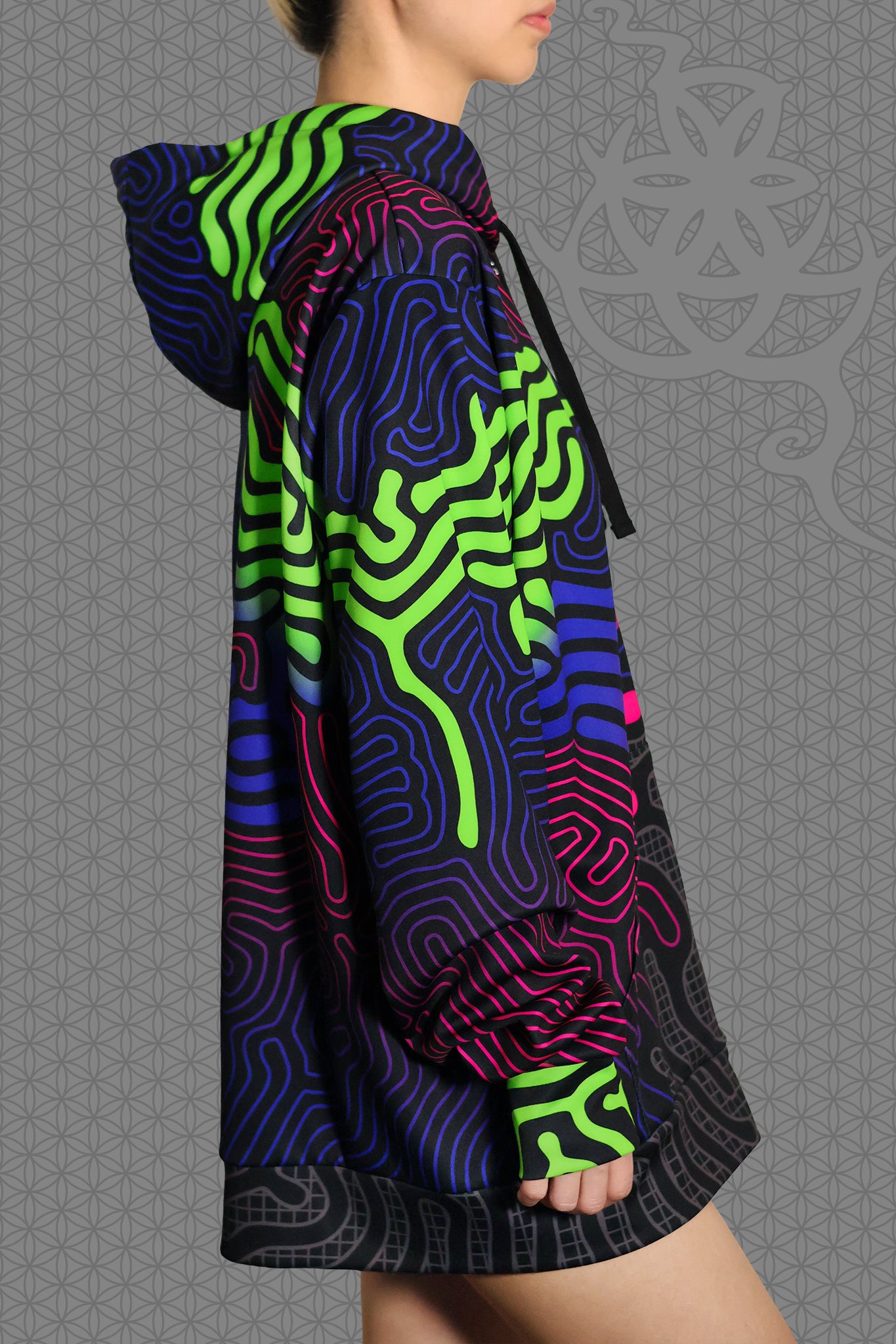 right view psychedelic rave zip hoodie with neon green, blue, and pink contour patterns on black with black fleece interior lining
