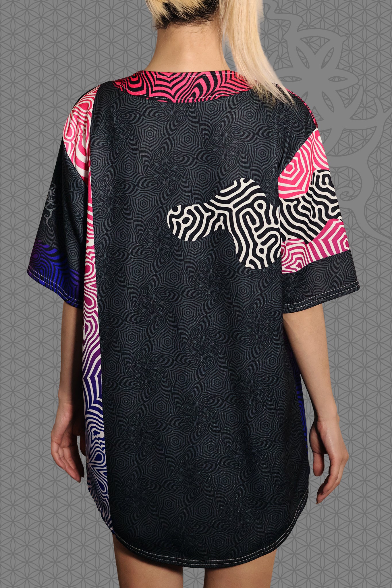 back view psychedelic rave baseball jersey with neon pink, purple, and blue geometric optical patterns and gradient panels