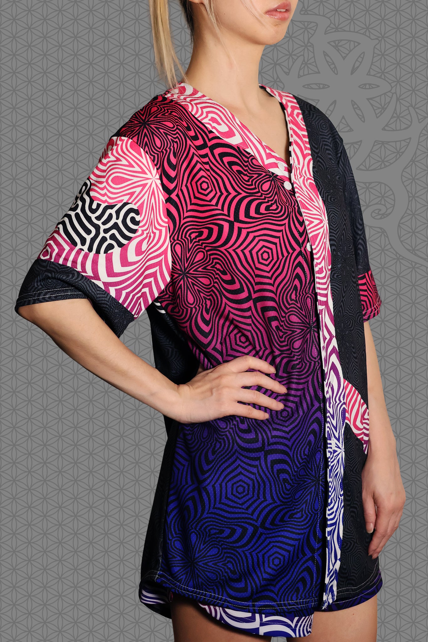 right view psychedelic rave baseball jersey with neon pink, purple, and blue geometric optical patterns and gradient panels