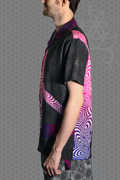 left view psychedelic rave camp shirt with neon pink, purple, and blue geometric optical patterns and gradient panels