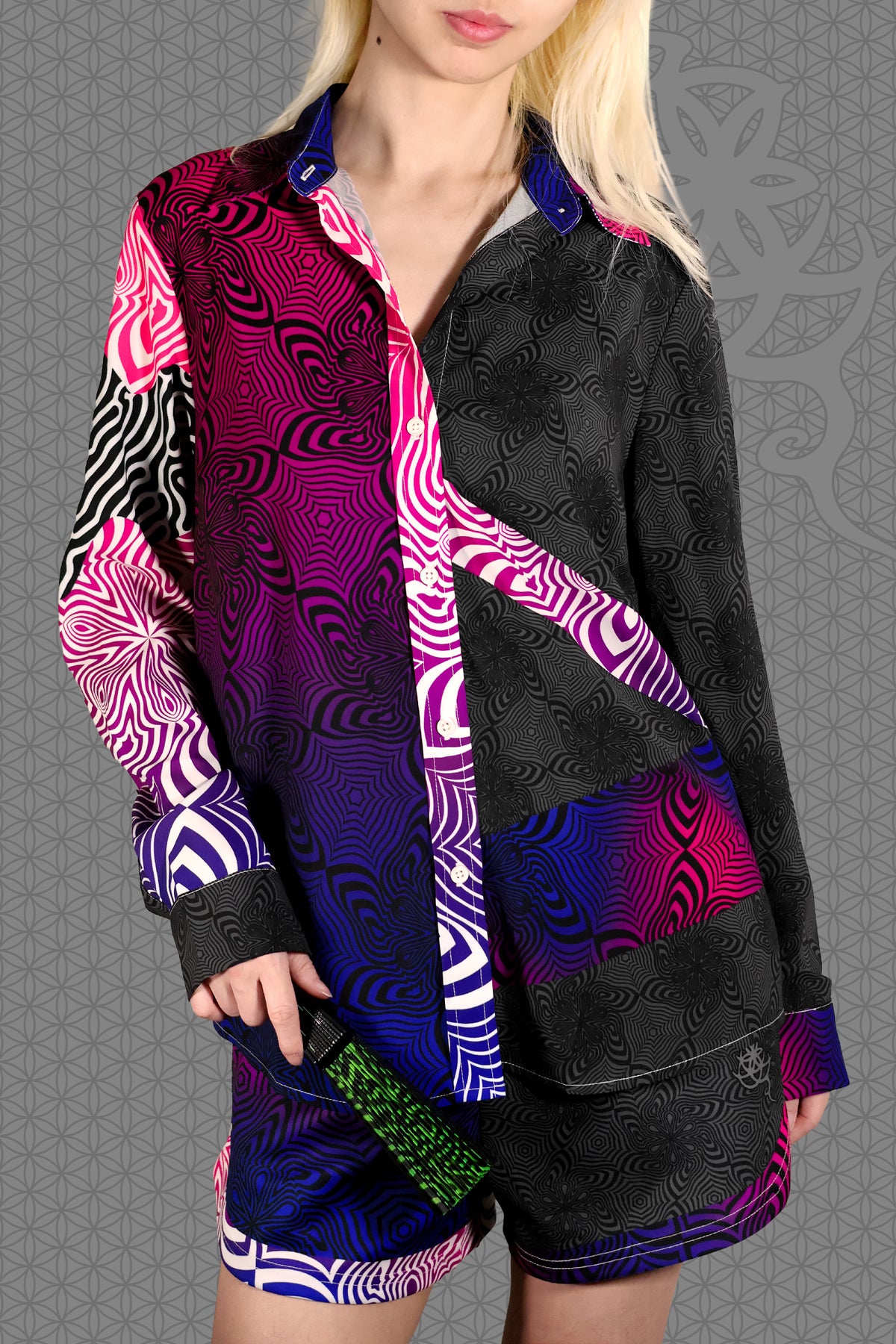 front view psychedelic rave women button up shirt with neon pink, purple, and blue geometric optical patterns and gradient panels