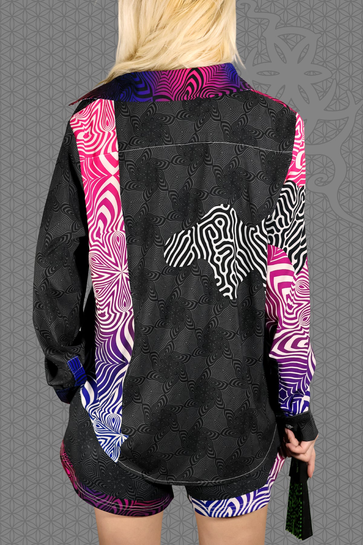back view psychedelic rave women button up shirt with neon pink, purple, and blue geometric optical patterns and gradient panels