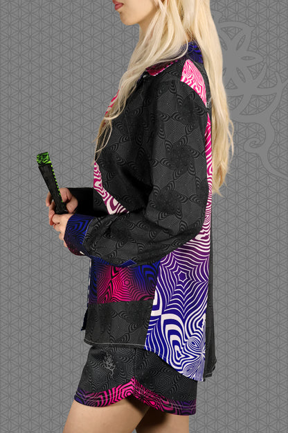 left view psychedelic rave women button up shirt with neon pink, purple, and blue geometric optical patterns and gradient panels