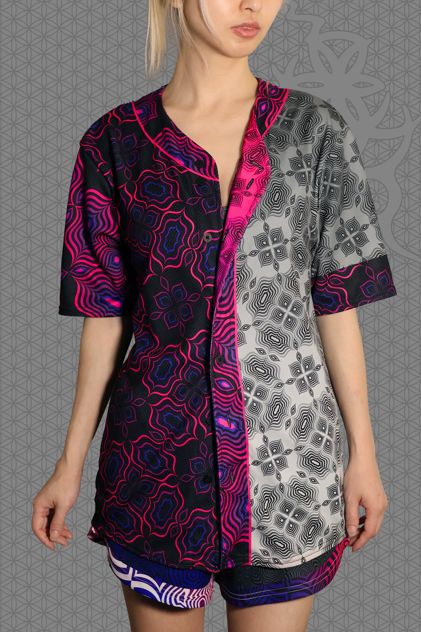 front view psychedelic rave baseball jersey with black and neon pink geometric optical patterns and contrasting gray psychedelic pattern panels
