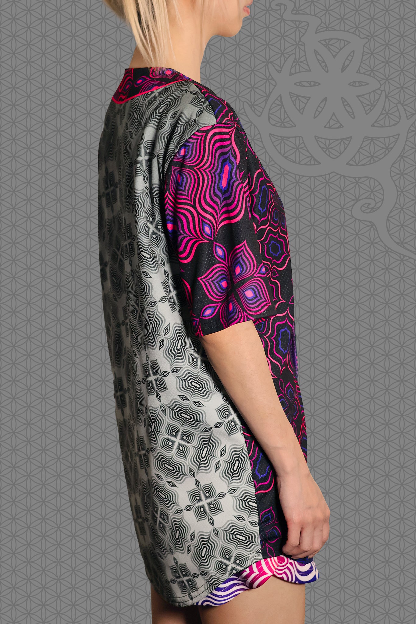 right view psychedelic rave baseball jersey with black and neon pink geometric optical patterns and contrasting gray psychedelic pattern panels
