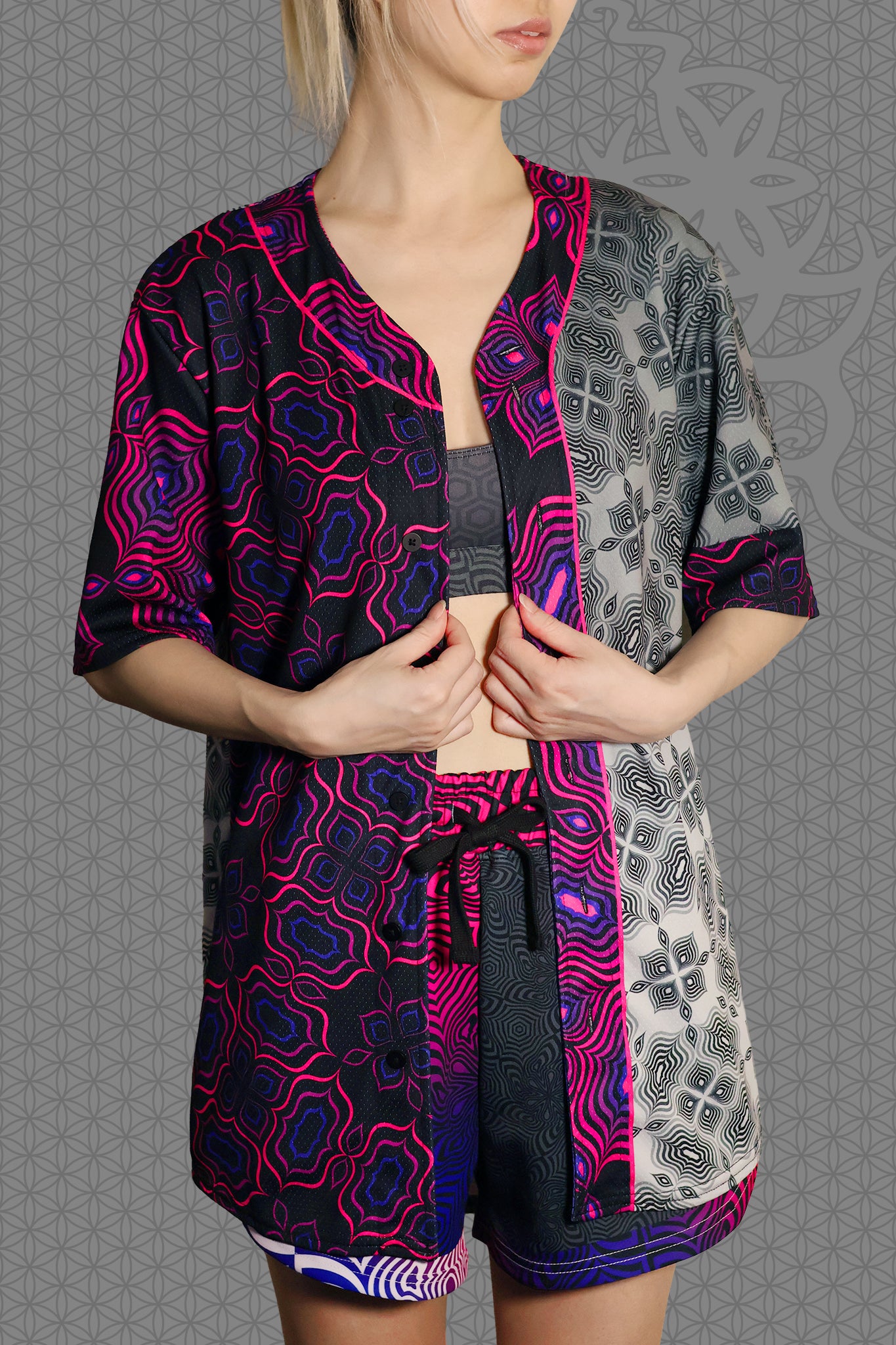 front view unbuttoned psychedelic rave baseball jersey with black and neon pink geometric optical patterns and contrasting gray psychedelic pattern panels
