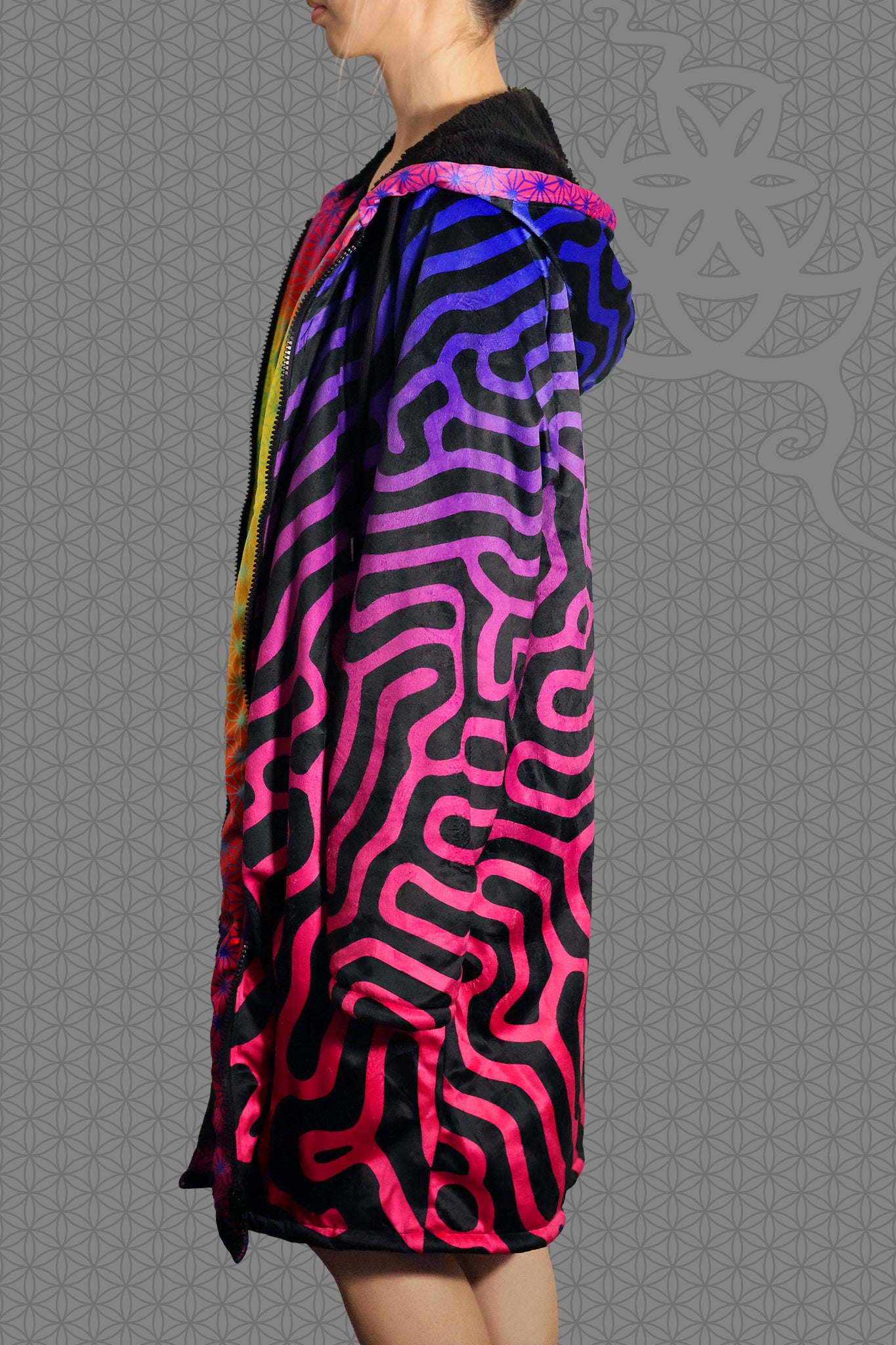 left view psychedelic hooded zip jacket with magenta-to-purple Turing pattern and reaction diffusion on black, contrasting rainbow geometric trim along the zipper and hood, and soft black fleece lining