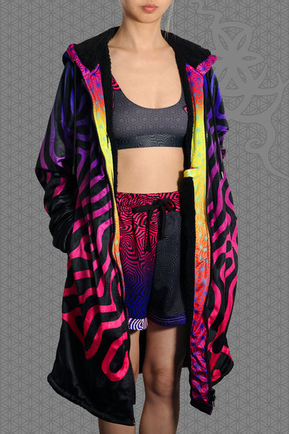 model view psychedelic hooded zip jacket with magenta-to-purple Turing pattern and reaction diffusion on black, contrasting rainbow geometric trim along the zipper and hood, and soft black fleece lining