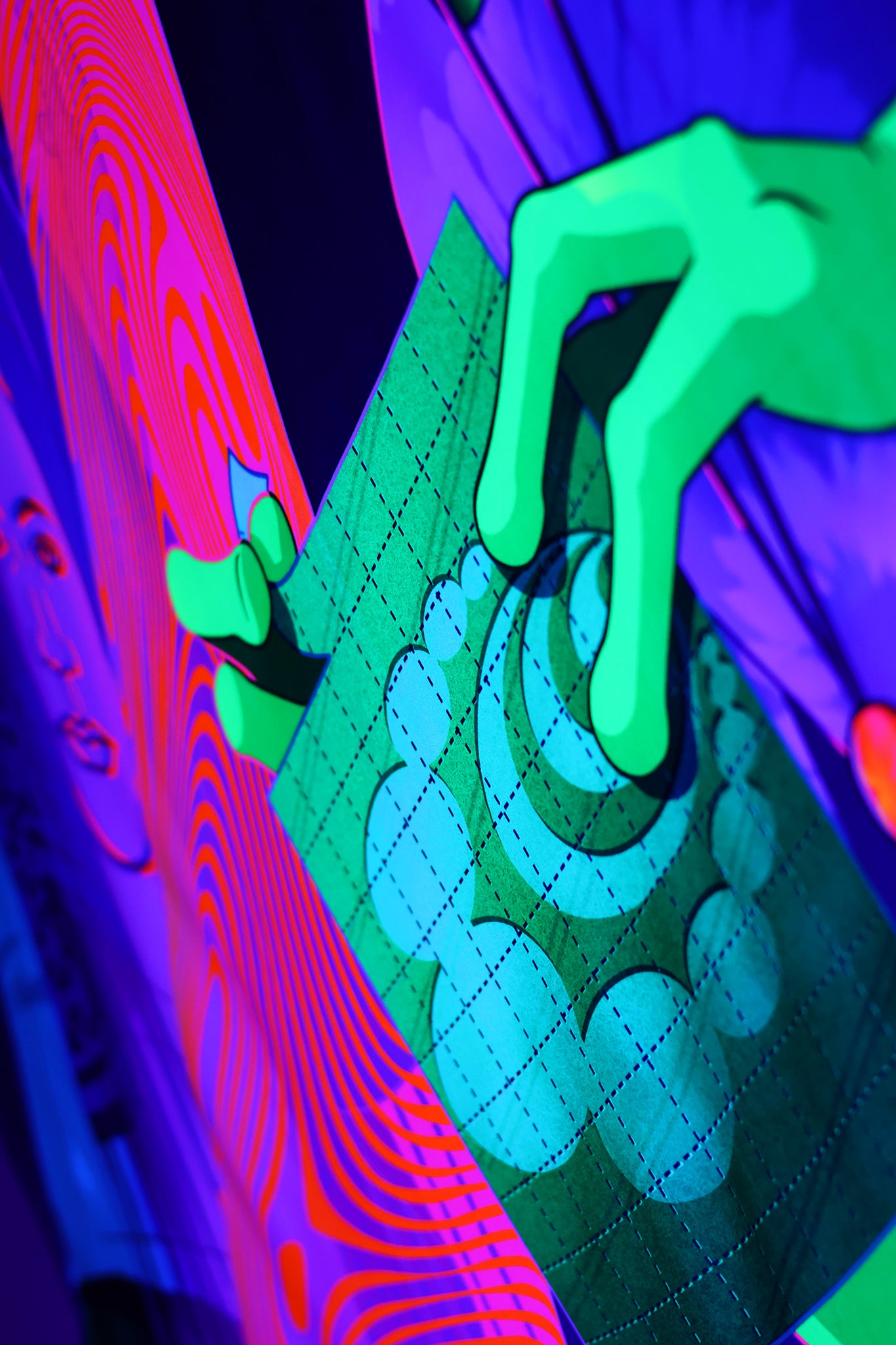 close-up view blacklight psychedelic tapestry with neon aliens at a desert rave under a UFO, palm trees, pink light beams