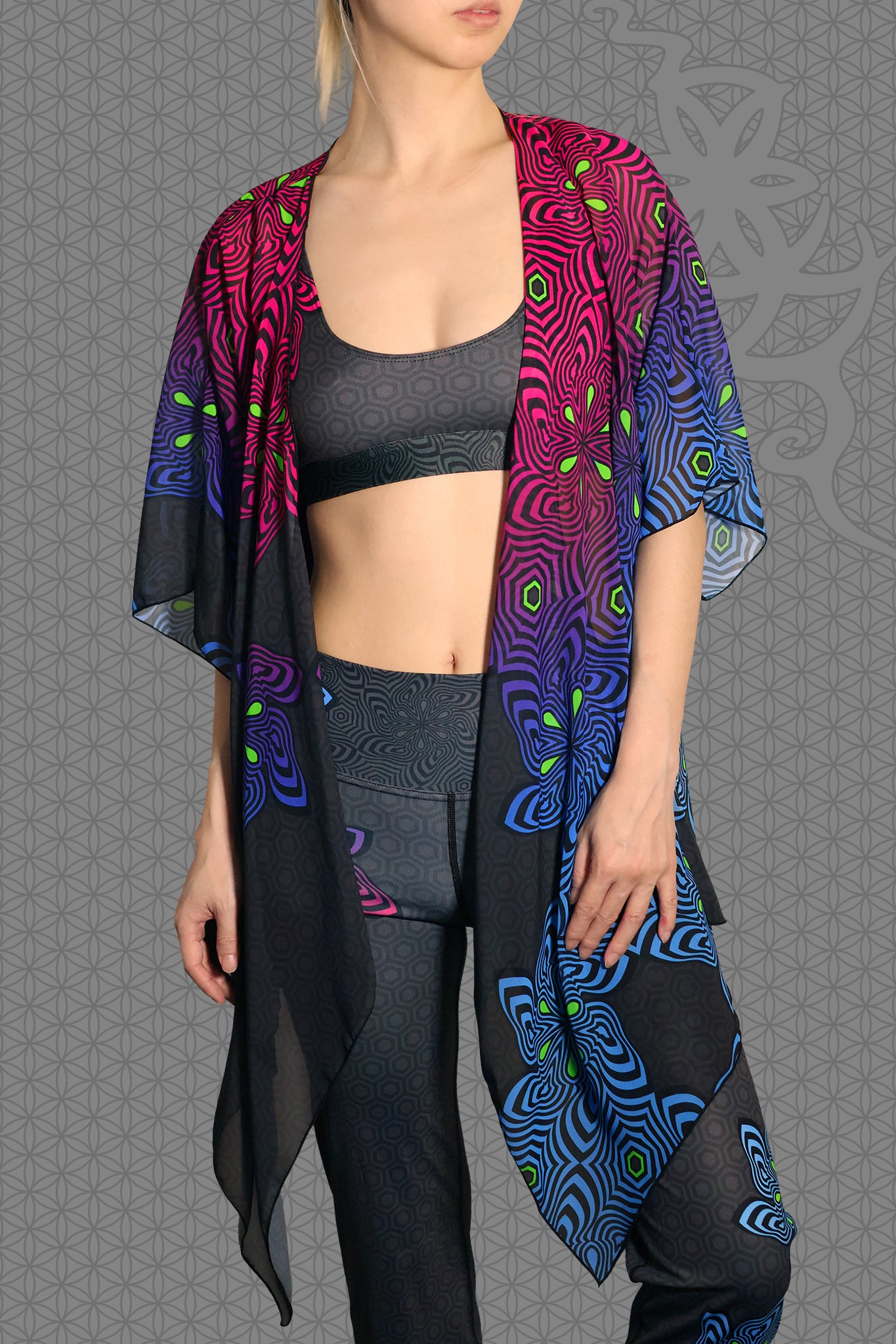 front view sheer chiffon psychedelic rave kimono with neon pink, purple, blue, and green geometric optical patterns on black