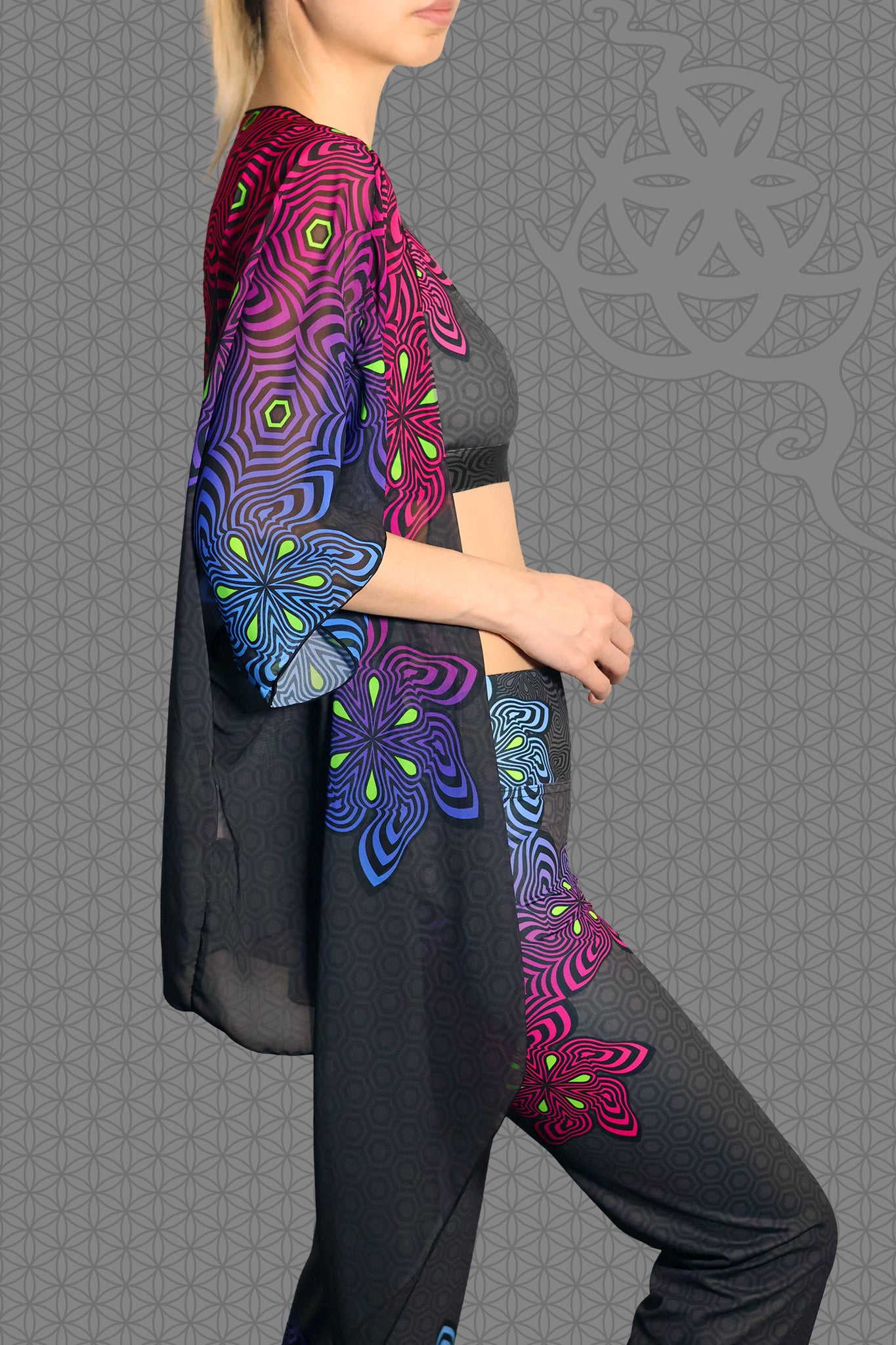 right view sheer chiffon psychedelic rave kimono with neon pink, purple, blue, and green geometric optical patterns on black