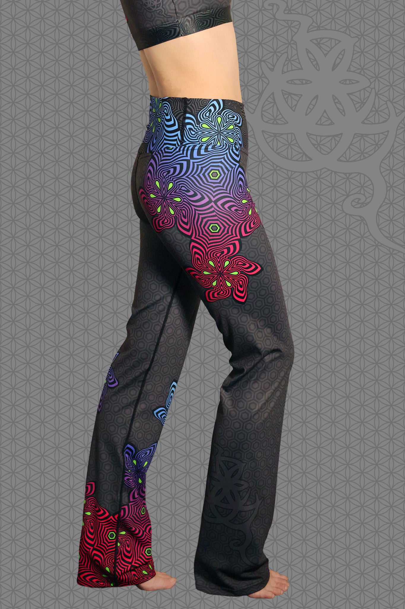 right view psychedelic rave flare leggings with neon pink, purple, blue, and green flower patterns on black