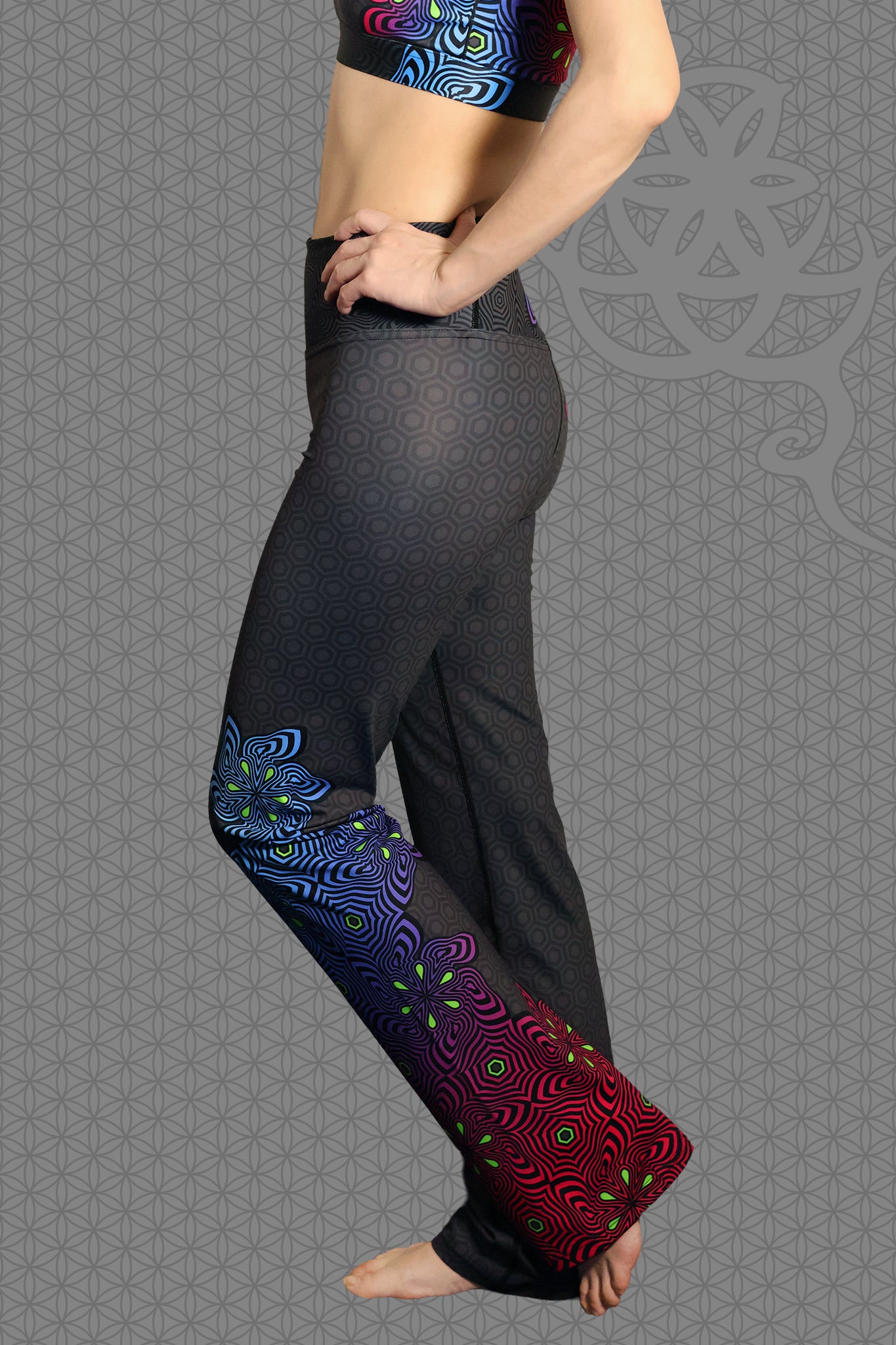left lay-flat view psychedelic rave flare leggings with neon pink, purple, blue, and green flower patterns on black